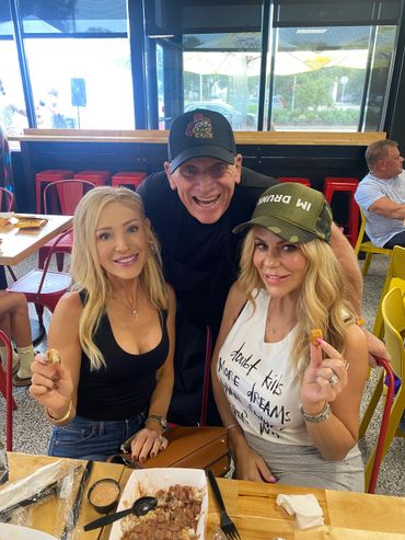Three people enjoying food together at a casual restaurant.