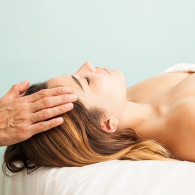 an image of a woman getting a head massage