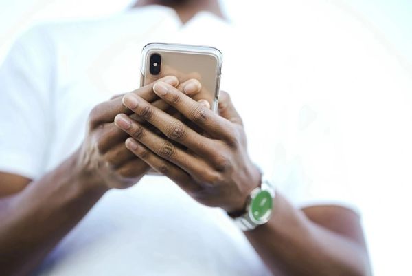 A pair of hands operating a smart phone