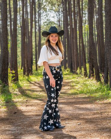 Cowgirl smiling while in the forest