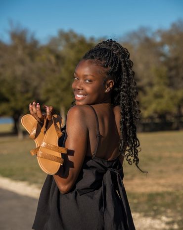 Beautiful girl with sun glow looking over her shoulders.