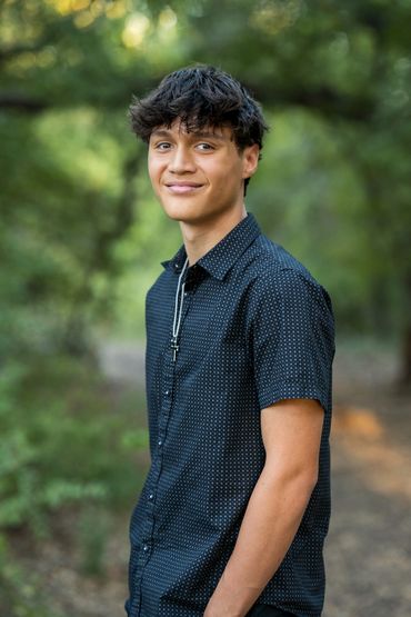 Guy standing in park smiling
