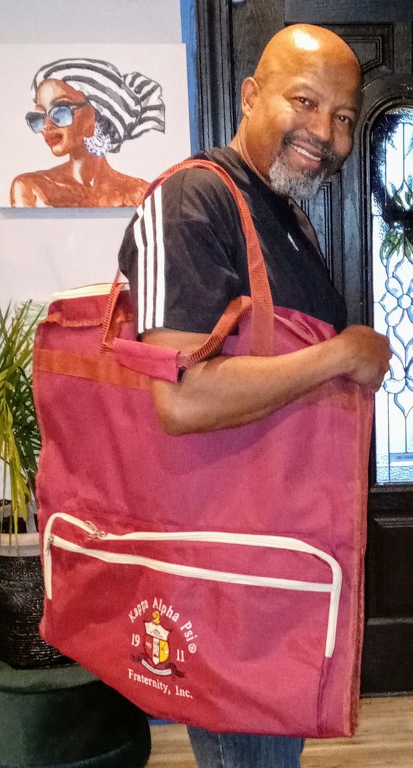 A man wearing red color bag posing