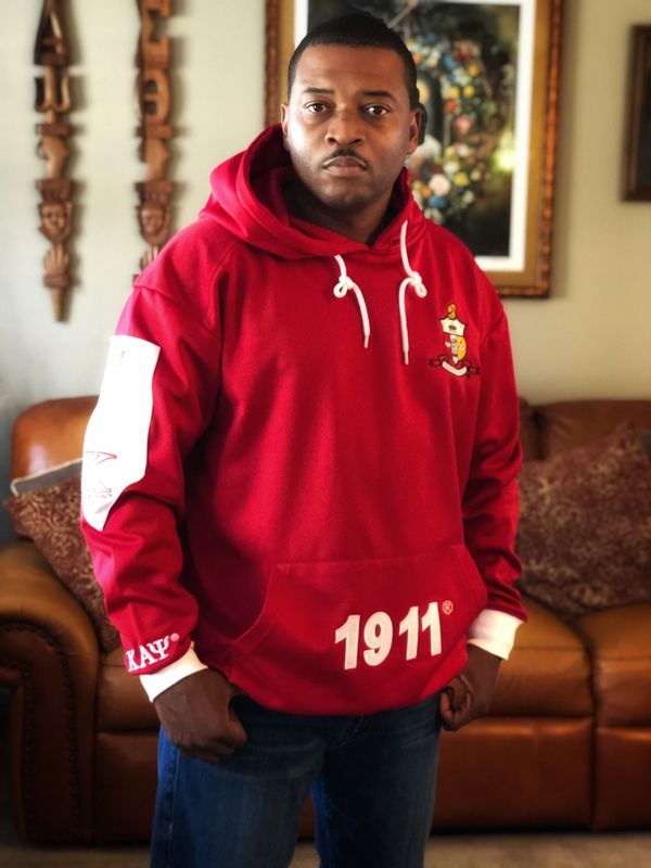 A man wearing red hoodie posing