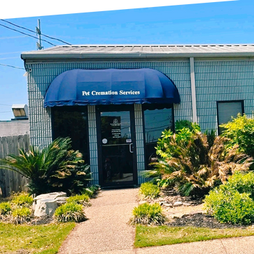 Entrance to a pet cremation services building with a blue awning.