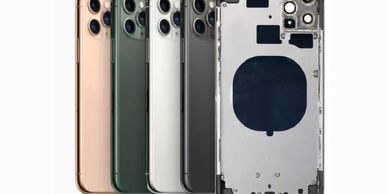 Five iPhone backs in different colors, including one disassembled showing internal structure.