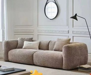 Cozy, modern brown sofa with plush cushions in a stylish living room.