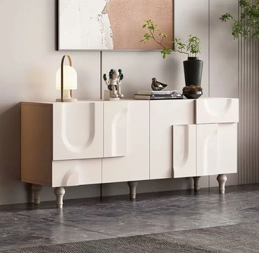 Modern cream-colored sideboard with decorative items and plants.