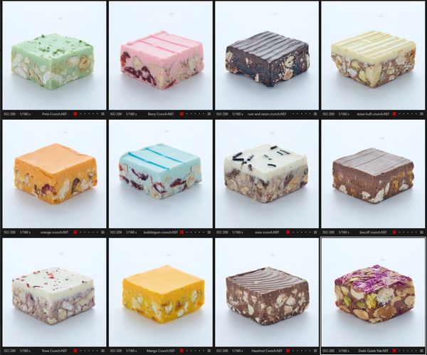Twelve varieties of colorful nut and fruit fudge squares.