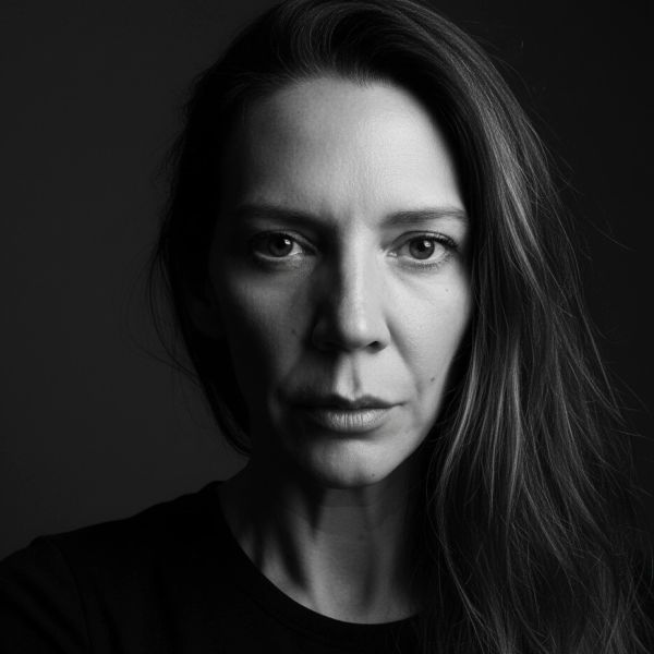 Black and white portrait of a serious woman with long hair.