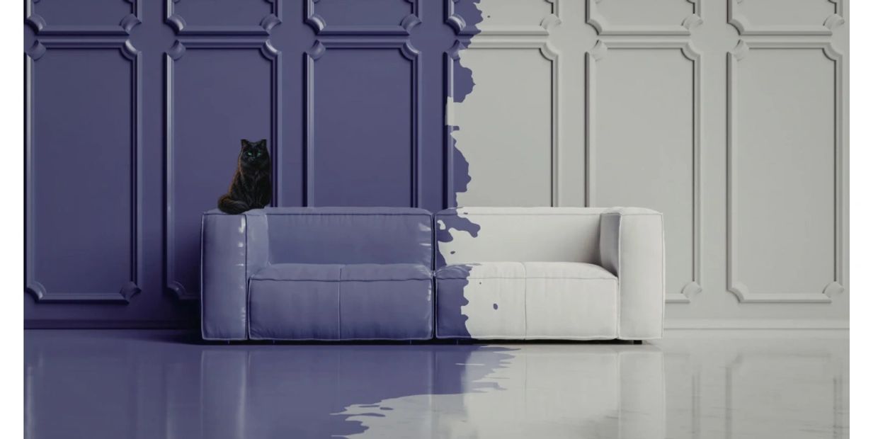 A two-tone sofa blending purple and white with a black cat sitting on it.