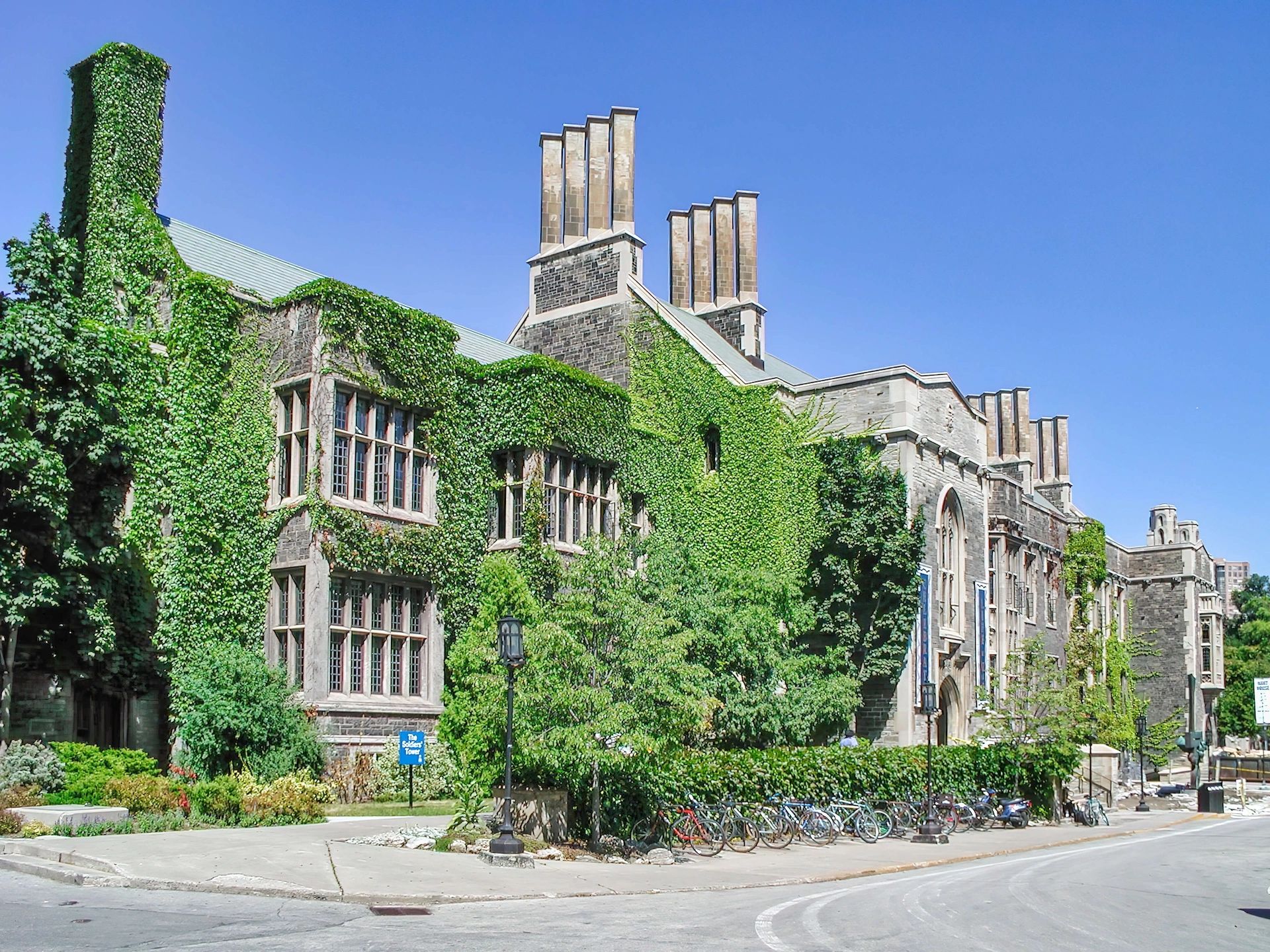 Hart House, University of Toronto — ivy-covered Gothic Revival stone building on a sunny summer day.