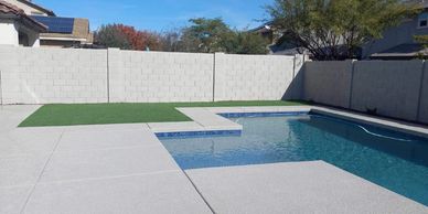 Backyard oasis with custom pavers by the pool, turf, and gravel installation