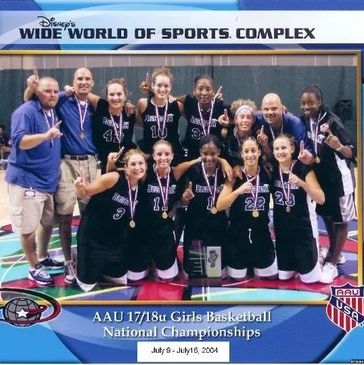 Girls basketball team posing with championship medals.