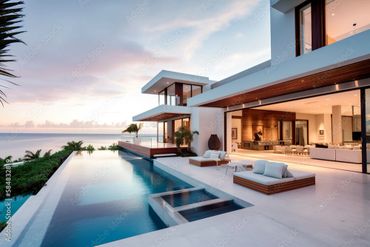 Modern luxury beach house with infinity pool and ocean view at sunset.