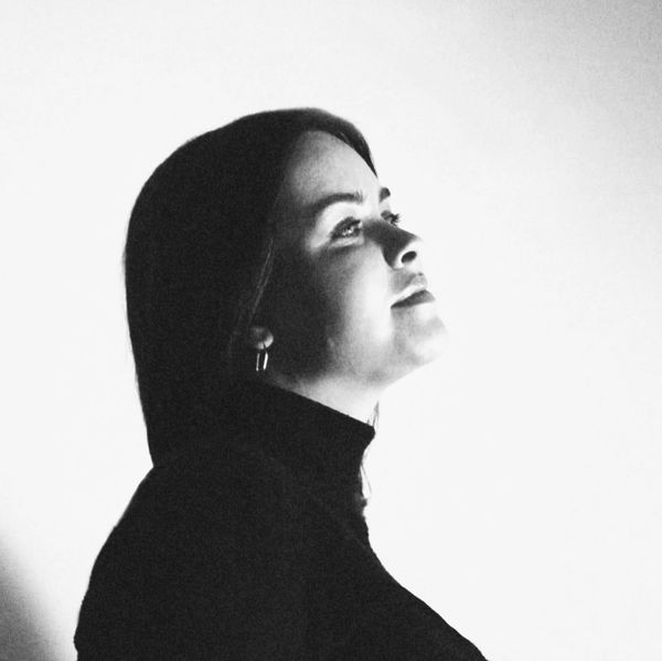 Black and white profile portrait of a woman looking upward.