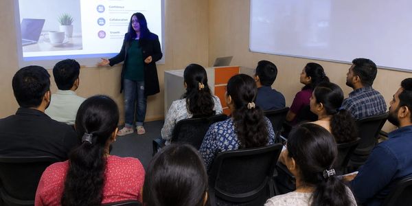 Woman giving a presentation to an attentive audience.