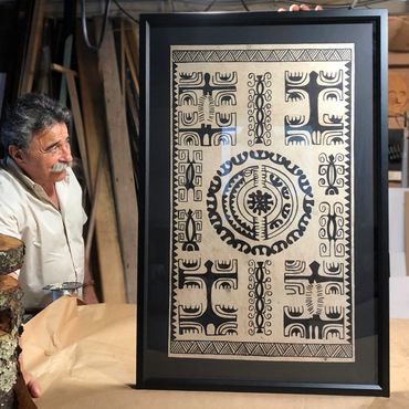 Cultural artwork in black beveled frame with black mat and happy client 