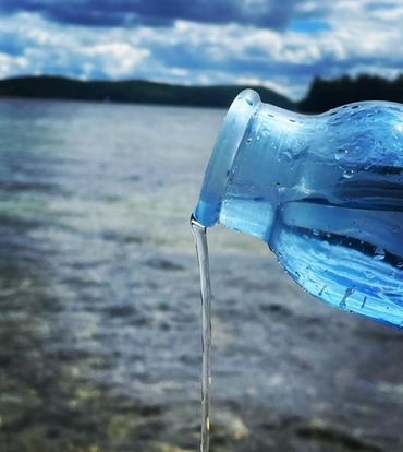 Om water bottle pouring water