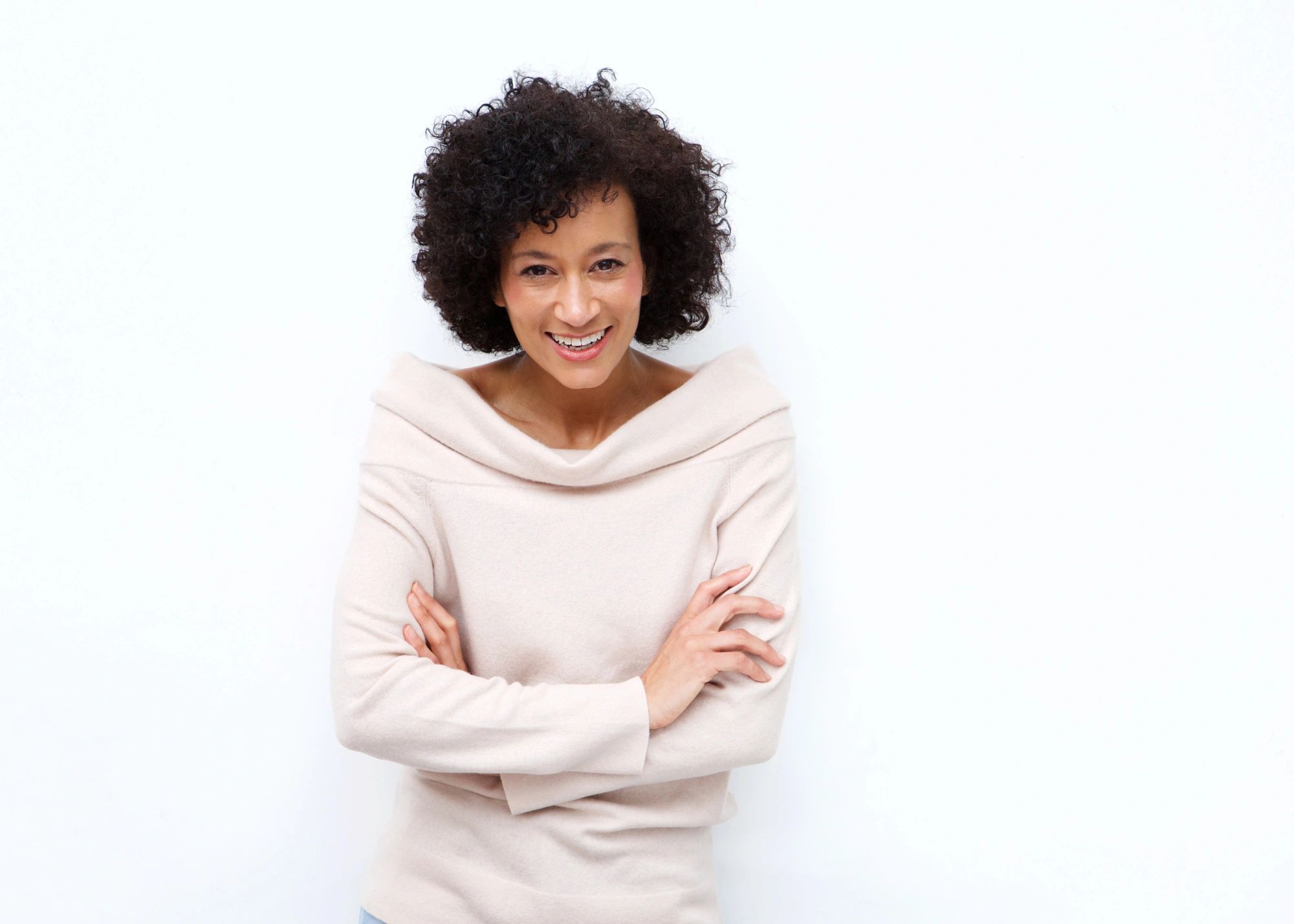 black woman, with fair skin, in white, looking happy and healthy