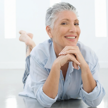 60 year old woman with short gray hair looking happy