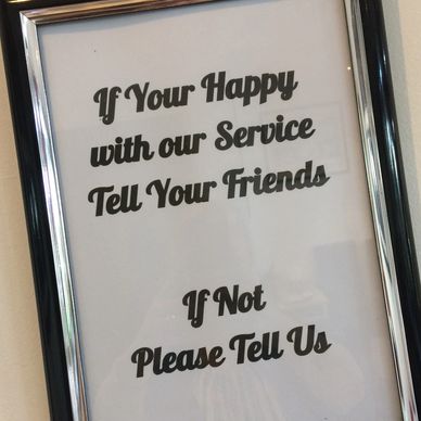 sign that reads "if you'r happy with our service tell your friends  if not please tell us"