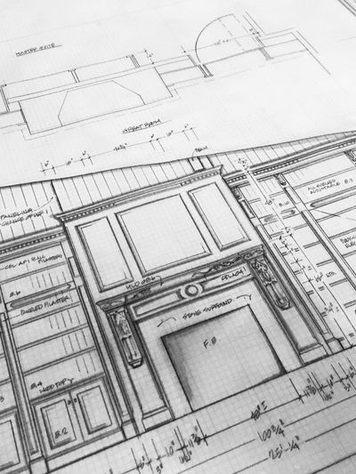 Close-up of a detailed architectural drawing of a fireplace and built-in shelves.