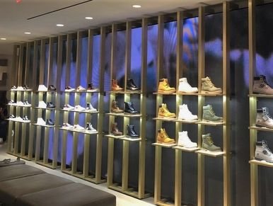 An LED  video wall behind the retail shoe display at Nordstrom Men's in New York, New York.