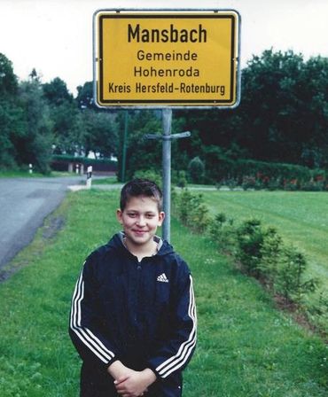 Partial view of yellow Mansbach town sign
