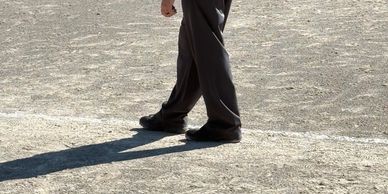 Baseball umpire standing on the field observing the game.