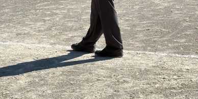 Baseball umpire standing on the field observing the game.