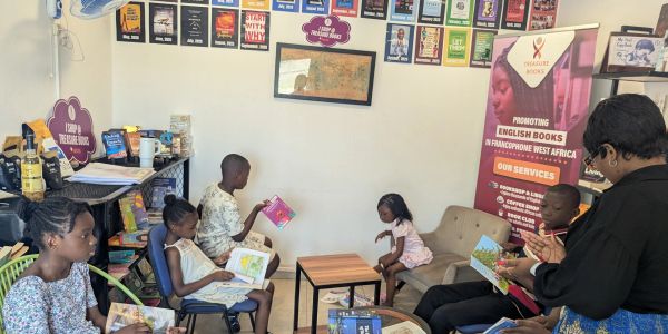 Children reading English books in a cozy room.
