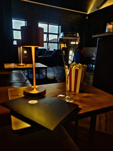 Cozy dimly-lit lounge with popcorn and champagne.