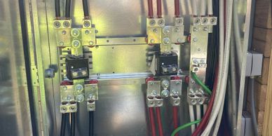 Electrical panel with organized wiring and connectors.