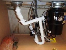 improper plumbing underneath kitchen sink