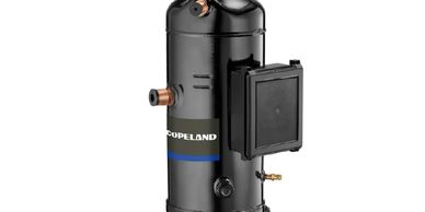 Black Copeland compressor with pipes and cover.