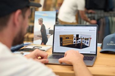 Rebuild Events team designing a 3D interior layout on a laptop for Florence Marine X.