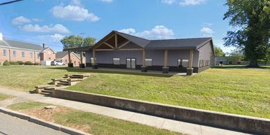 New modern building on a green lawn under a blue sky.