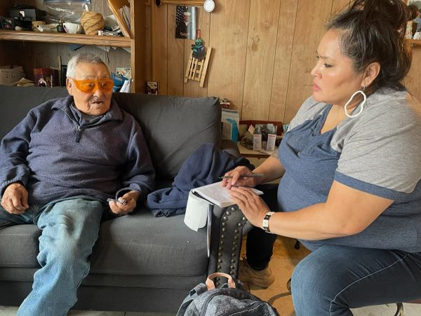 A conversation between an elderly man and woman with notes.