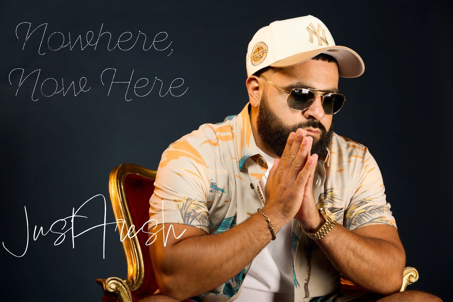Man in sunglasses and cap, hands clasped, with text 'Nowhere, None Here Just Aresh'.