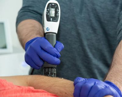 Person receiving ultrasound therapy on the arm.
