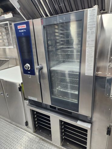 Commercial Rational iCombi Pro oven in a stainless steel kitchen setup.
