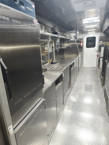 Interior of a professional stainless steel commercial kitchen.
