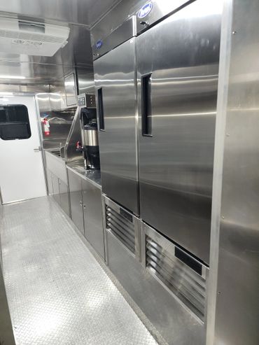 Interior of a stainless steel commercial kitchen or food truck.