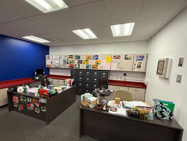 Admin office painted white with blue accent wall.