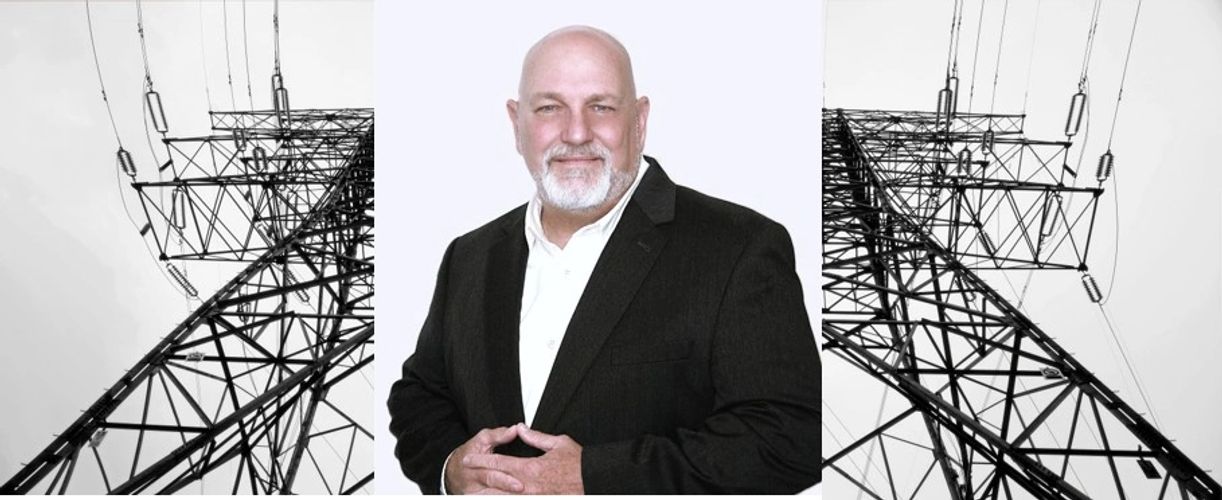 Confident man in suit with power lines on either side symbolizing energy leadership.