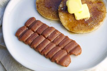 Shaped purée bacon strips with shaped purée bread pancakes. IDDSI safe texture.