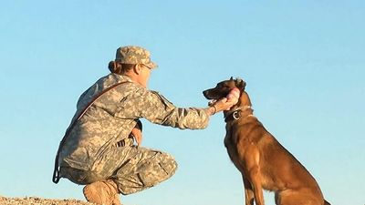Woman sitting and keeping her hand on her head in her kurta