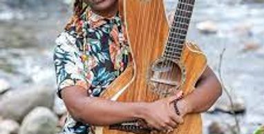 A woman taking guitar on the hand and see on the front