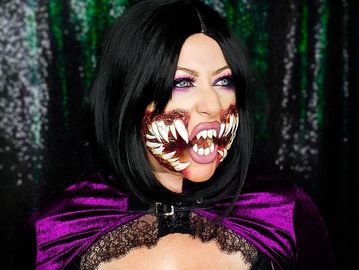 Person with vampire-themed makeup and teeth.